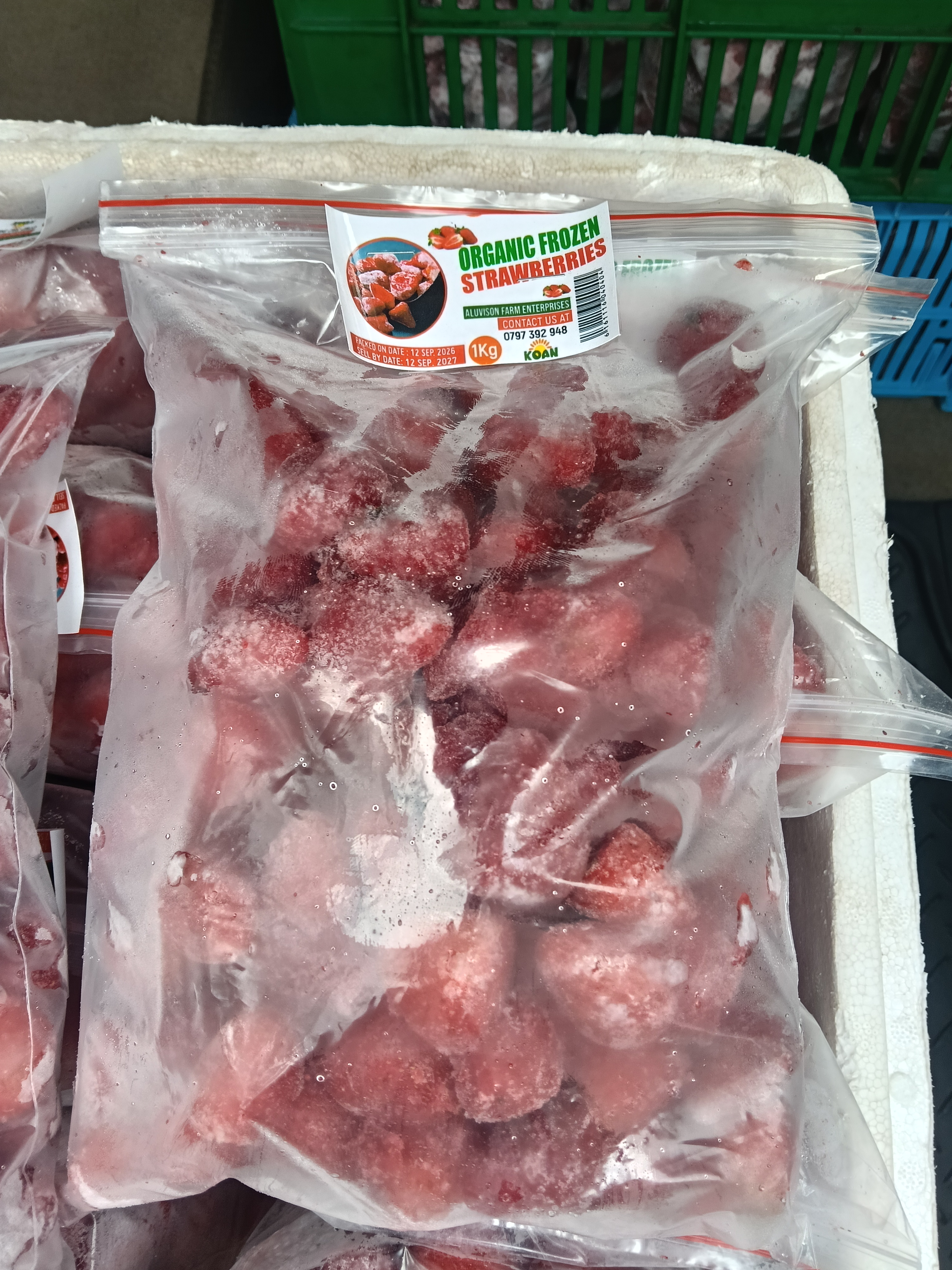 Close-up of a sealed pack of Aluvison organic frozen strawberries